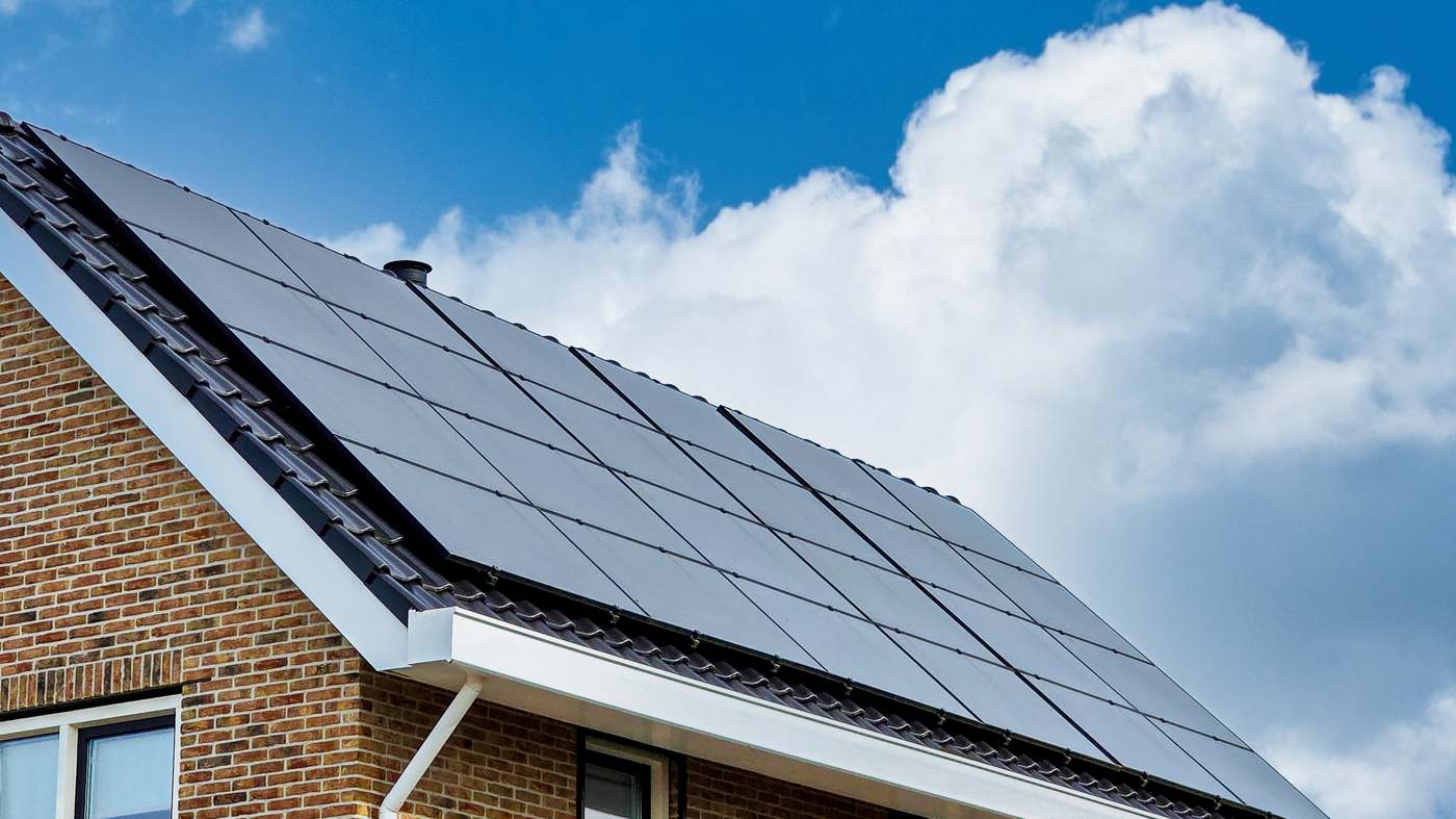 Solar panels installed on the roof of a brick house