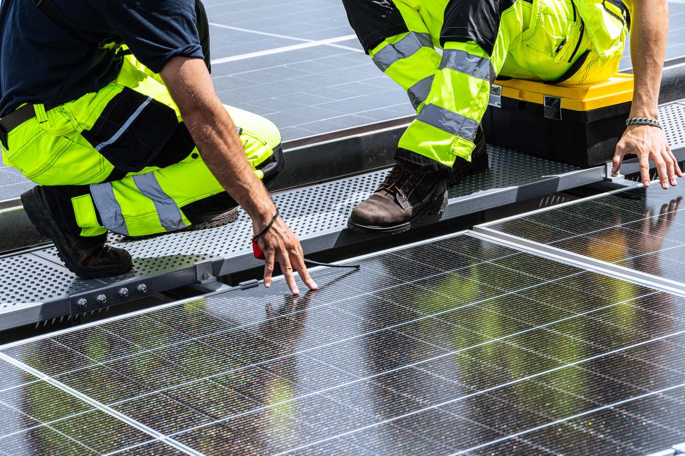 ECC engineers installing solar panels on a commercial roof